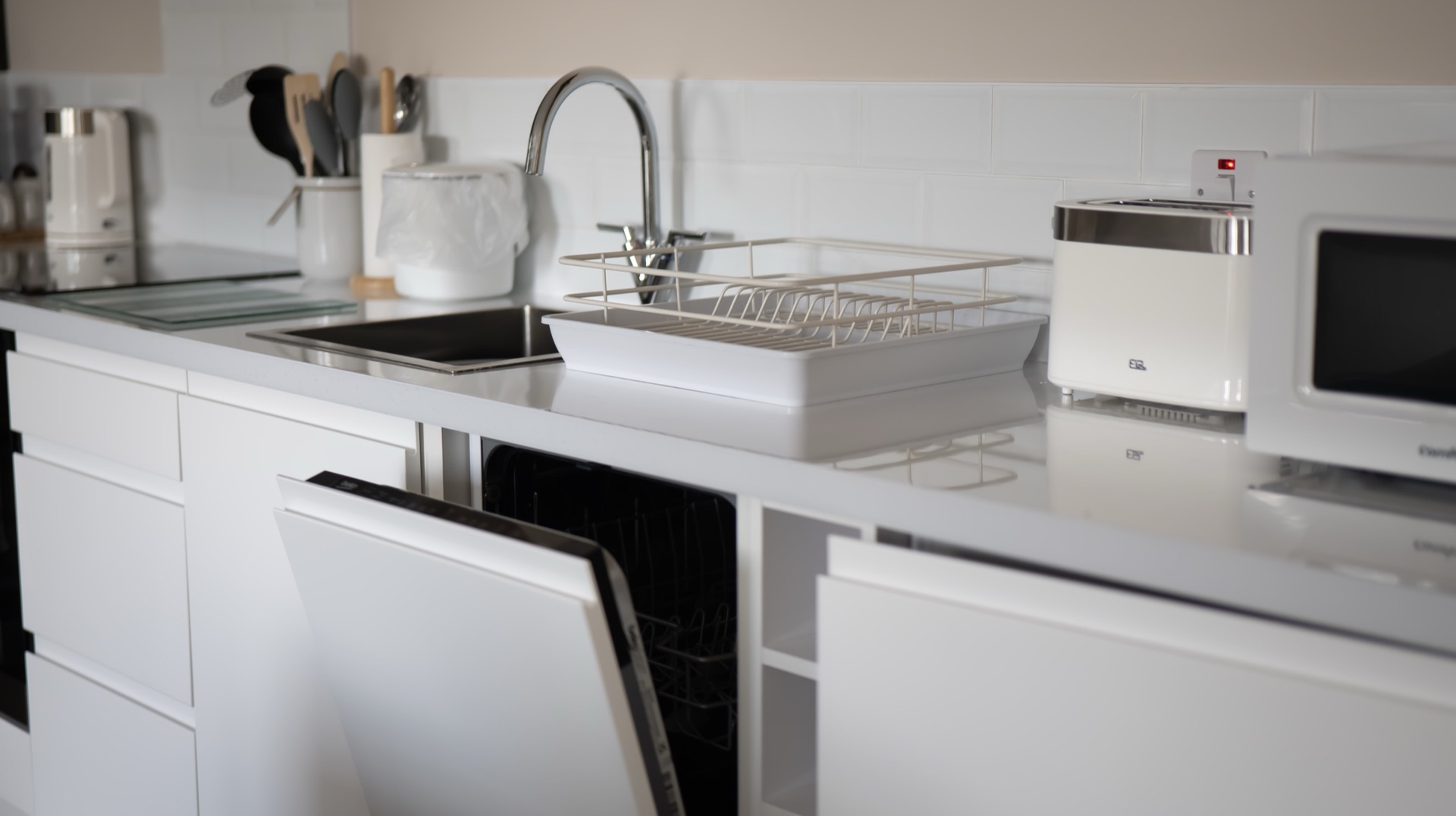 Oak kitchen worktop with sink, kettle, toaster, microwave and integrated dishwasher